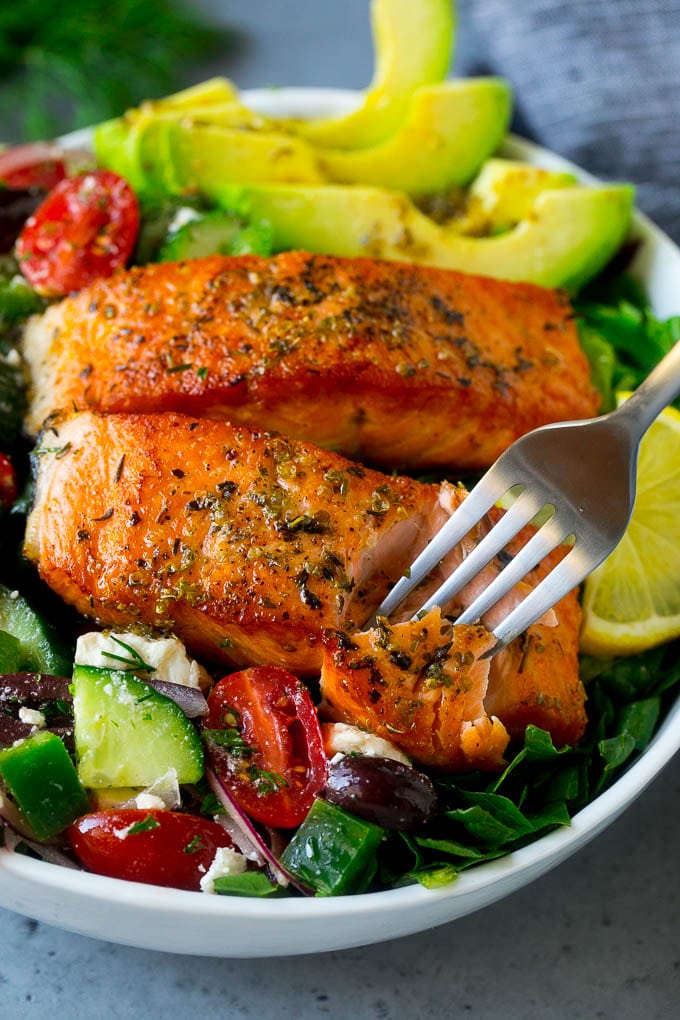 Greek Salmon Salad Recipe | Low Carb Salmon Recipe | Salmon Salad #salmon #seafood #fish #lowcarb #keto #lunch #jonep #healthy A fork cutting into a salmon fillet in Greek salmon salad.