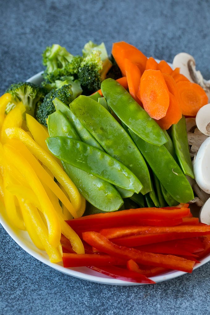 Vegetable Stir Fry Recipe | Veggie Stir Fry | Broccoli Stir Fry #vegetarian #vegetables #broccoli #dinner #jonep Bell peppers, snow peas, carrots, mushrooms and broccoli on a plate.