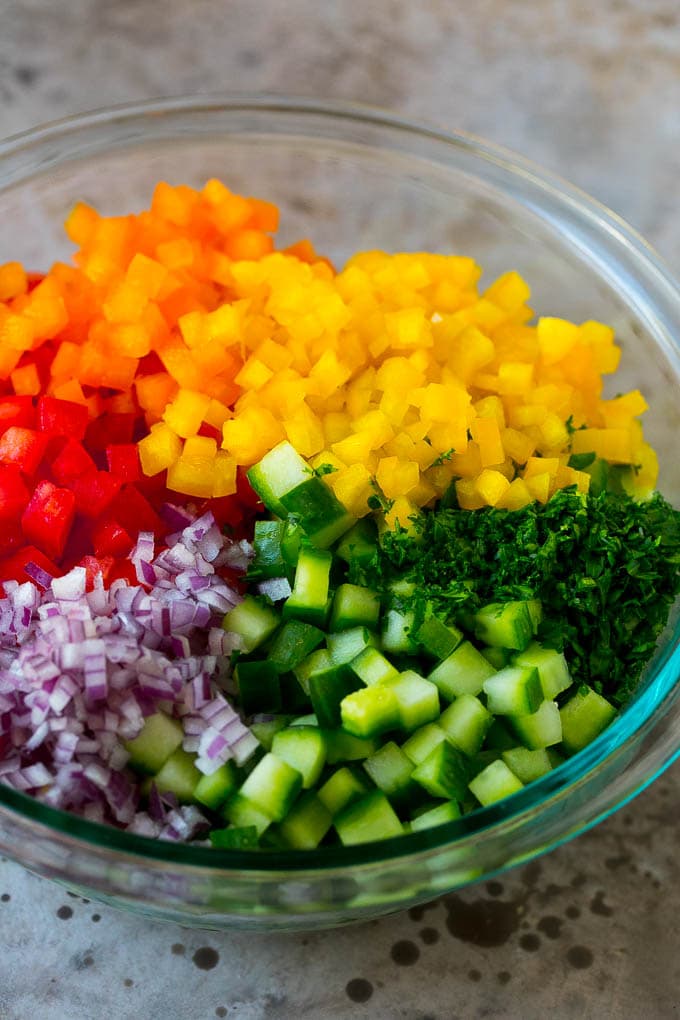 Israeli Salad Recipe | Cucumber Salad | Tomato Salad | Chopped Salad #salad #cleaneating #healthy #glutenfree #lowcarb #keto #sidedish #lunch #jonep Chopped peppers, cucumbers, tomatoes and onions in a bowl.