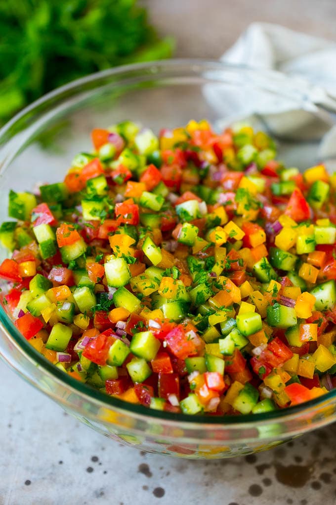 Israeli Salad Recipe | Cucumber Salad | Tomato Salad | Chopped Salad #salad #cleaneating #healthy #glutenfree #lowcarb #keto #sidedish #lunch #jonep Israeli salad with cucumbers and tomatoes in a serving bowl.