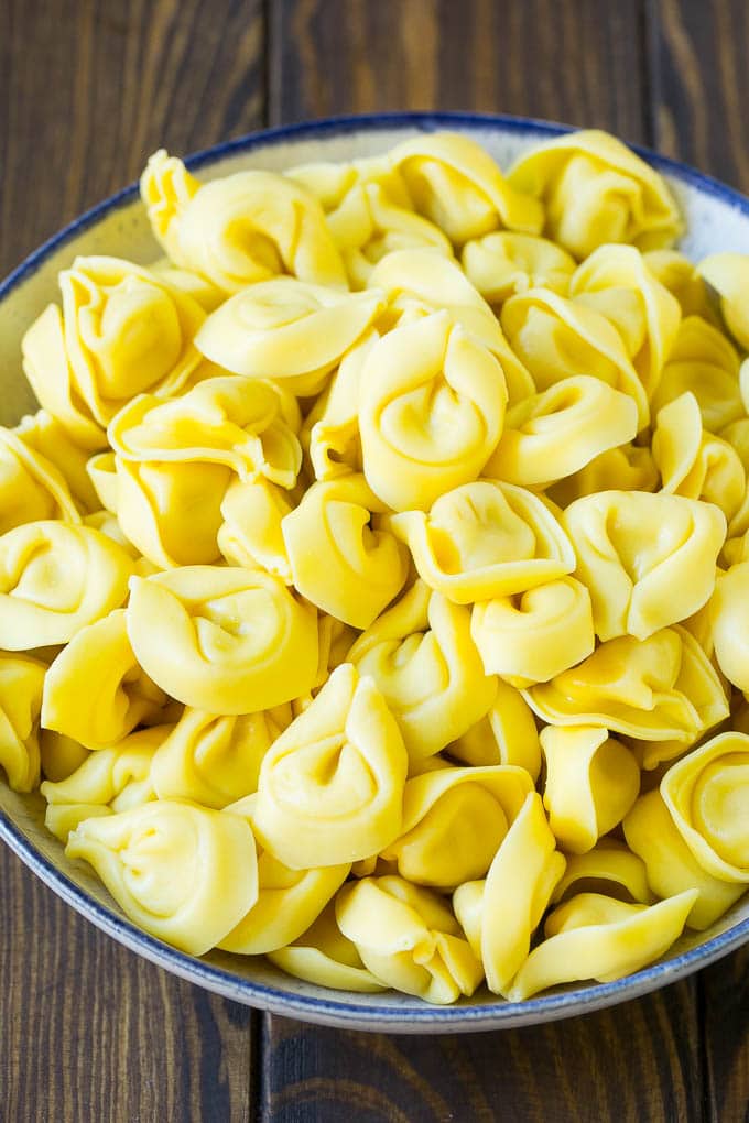Greek Tortellini Salad Recipe | Pasta Salad | Tortellini Salad | Greek Salad #greek #tortellini #pasta #salad #cucumbers #olives #dinner #jonep A bowl of cooked cheese tortellini.