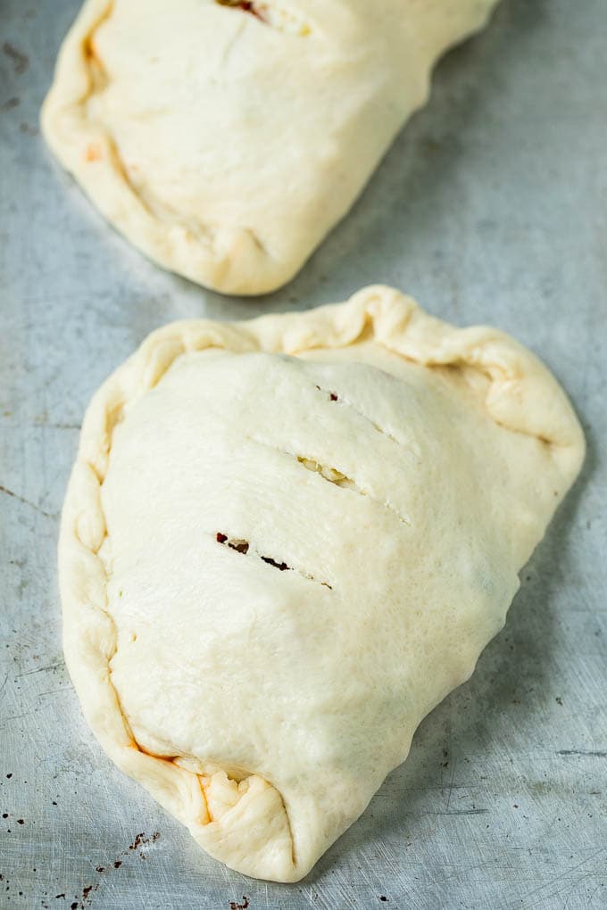 Calzone Recipe | Pizza Pockets #pizza #calzone #pepperoni #sausage #peppers #dinner #jonep #cheese Unbaked calzones ready to go into the oven.