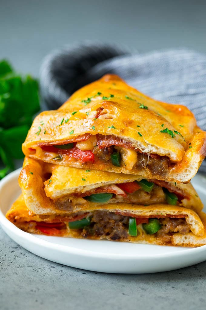 Calzone Recipe | Pizza Pockets #pizza #calzone #pepperoni #sausage #peppers #dinner #jonep #cheese Calzone halves stuffed with sausage, peppers, cheese and pepperoni.