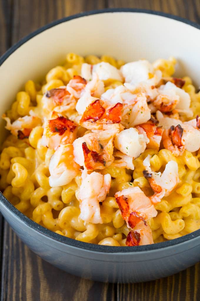 Lobster Mac and Cheese Recipe | Lobster Macaroni and Cheese | Baked Mac and Cheese #pasta #macandcheese #macaroni #lobster #cheese #dinner #jonep Stove top mac and cheese topped with pieces of cooked lobster.
