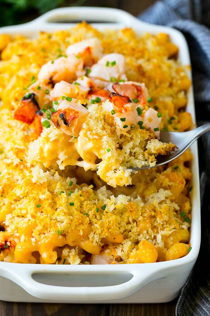 Lobster Mac and Cheese Recipe | Lobster Macaroni and Cheese | Baked Mac and Cheese #pasta #macandcheese #macaroni #lobster #cheese #dinner #jonep A spoon serving up a portion of lobster mac and cheese.