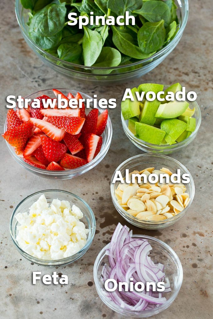 Strawberry Spinach Salad Recipe | Strawberry Salad | Spinach Salad #spinach #salad #strawberries #avocado #jonep Bowls of ingredients like feta cheese, almonds, red onion and avocado.