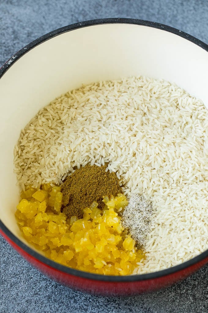 Black Beans and Rice Recipe | Cuban Black Beans | Beans and Rice #beans #rice #blackbeans #sidedish #glutenfree #dinner #jonep Onions, garlic, white rice and spices in a pot.
