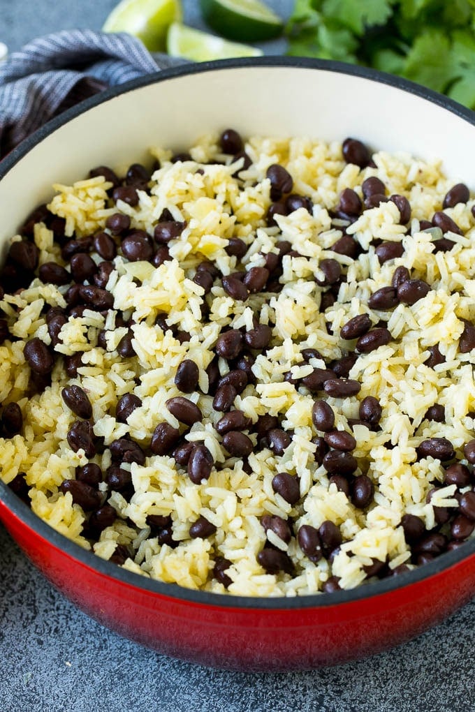 Black Beans and Rice Recipe | Cuban Black Beans | Beans and Rice #beans #rice #blackbeans #sidedish #glutenfree #dinner #jonep Rice and beans mixed together in a red pot.