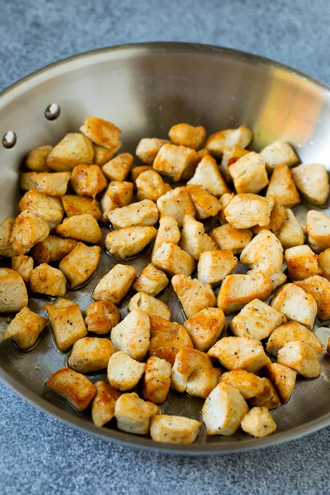 Chicken Fried Rice Recipe | Chinese Fried Rice #rice #chicken #peas #carrots #sidedish #dinner #jonep Cooked chicken pieces in a metal pan.