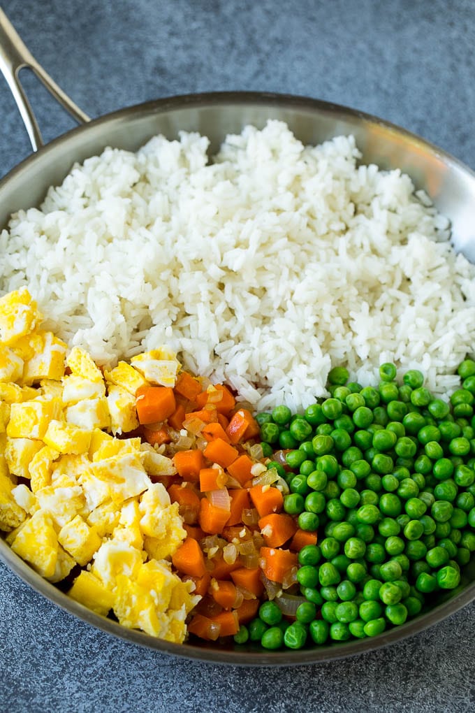 Chicken Fried Rice Recipe | Chinese Fried Rice #rice #chicken #peas #carrots #sidedish #dinner #jonep A pan of cooked rice, carrots, eggs and peas.