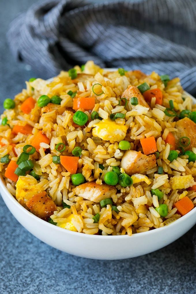 Chicken Fried Rice Recipe | Chinese Fried Rice #rice #chicken #peas #carrots #sidedish #dinner #jonep A bowl of chicken fried rice topped with sliced green onions.