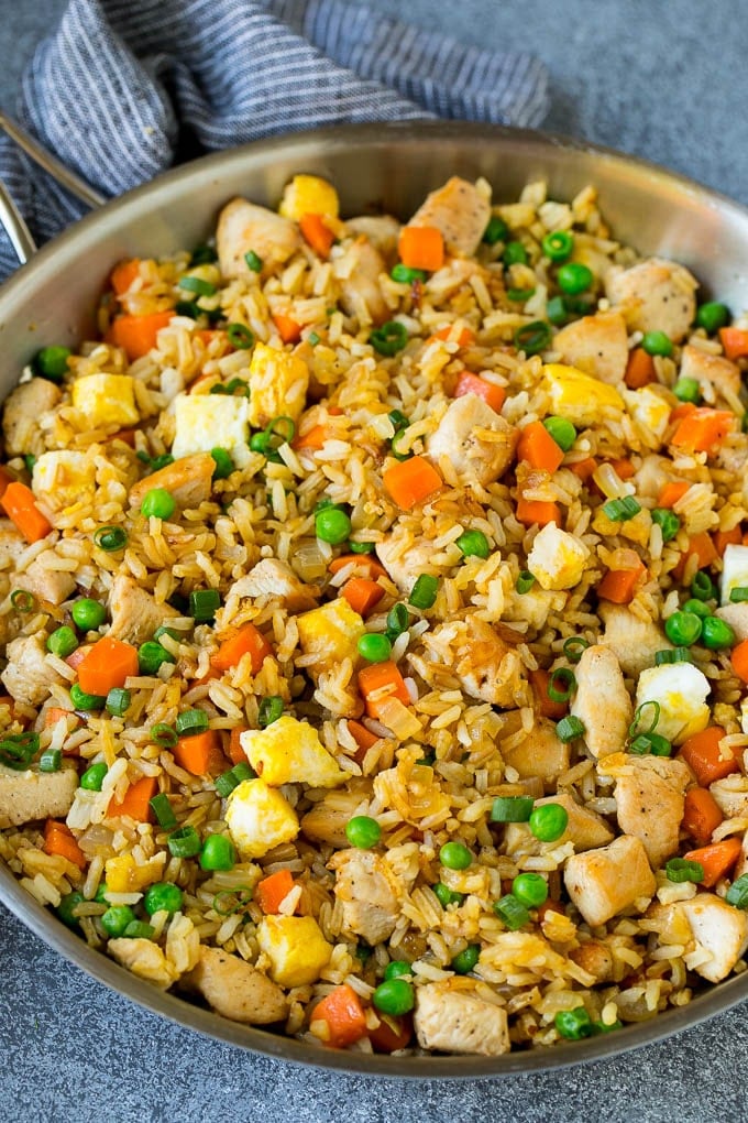 Chicken Fried Rice Recipe | Chinese Fried Rice #rice #chicken #peas #carrots #sidedish #dinner #jonep A pan of chicken fried rice with eggs and vegetables.