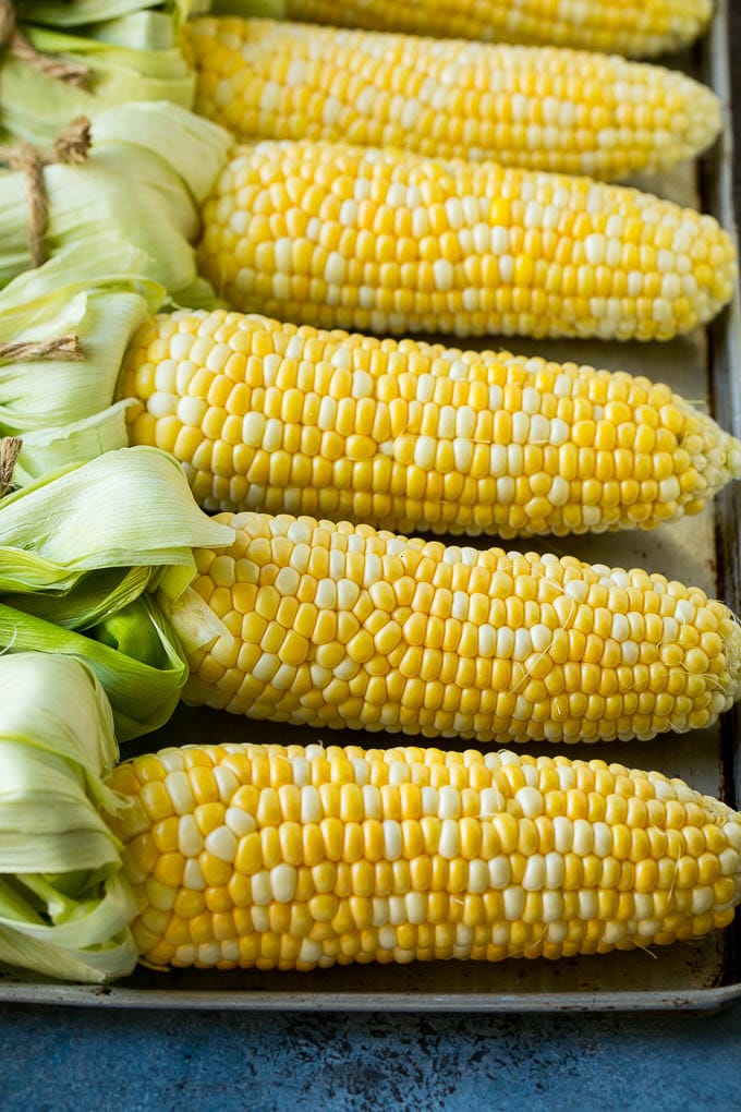 Grilled Corn on the Cob Recipe | Corn Recipe #corn #grilling #summer #sidedish #dinner #jonep Corn cobs on a sheet pan.