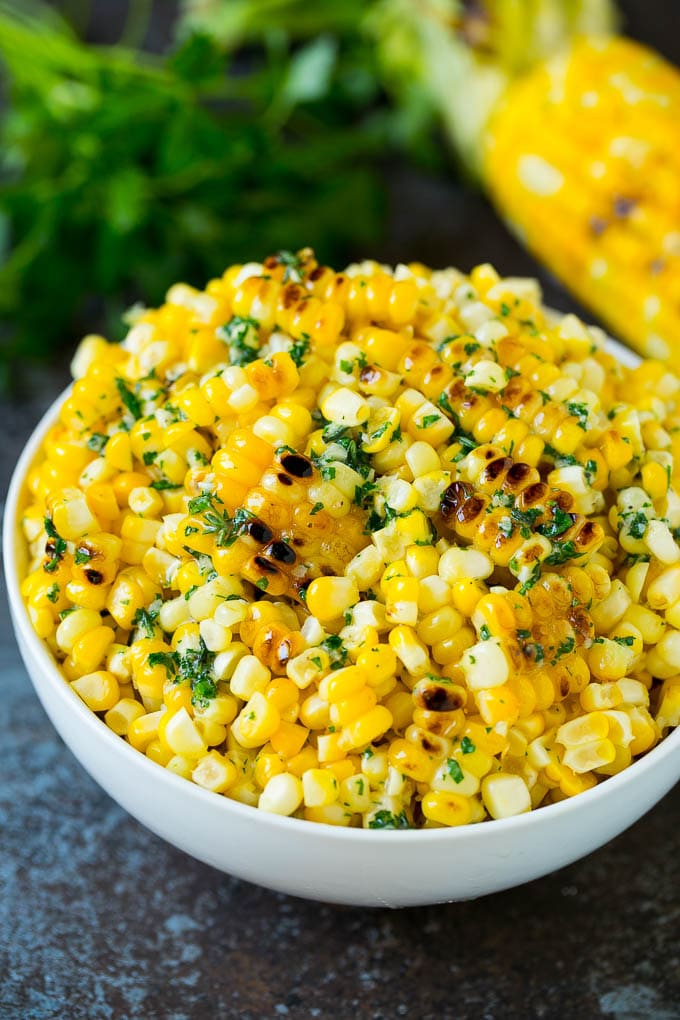 Grilled Corn on the Cob Recipe | Corn Recipe #corn #grilling #summer #sidedish #dinner #jonep Grilled corn cut off the cob with herb butter in a bowl.