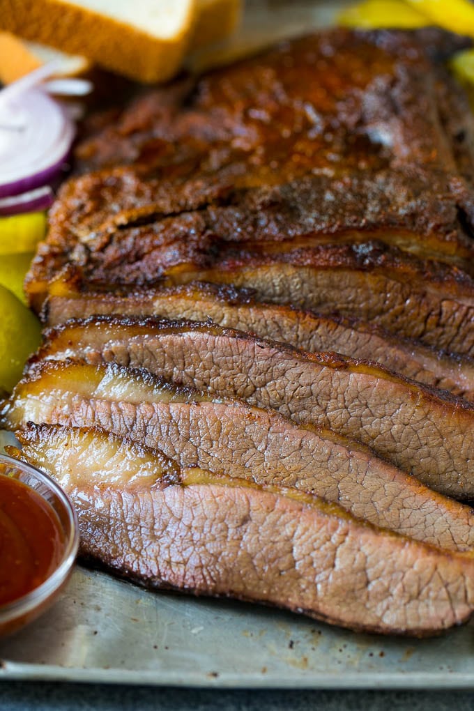 Smoked Brisket Recipe | Beef Brisket | BBQ Beef #brisket #smoker #beef #bbq #dinner #jonep Sliced smoked brisket with a side of BBQ sauce.