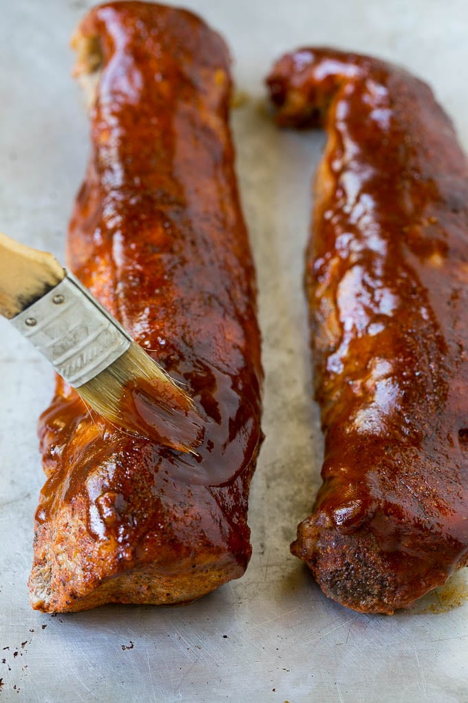 Smoked Pork Tenderloin Recipe | Smoked Pork Loin | BBQ Pork #pork #tenderloin #smoker #dinner #jonep BBQ sauce being brushed over smoked pork loin.