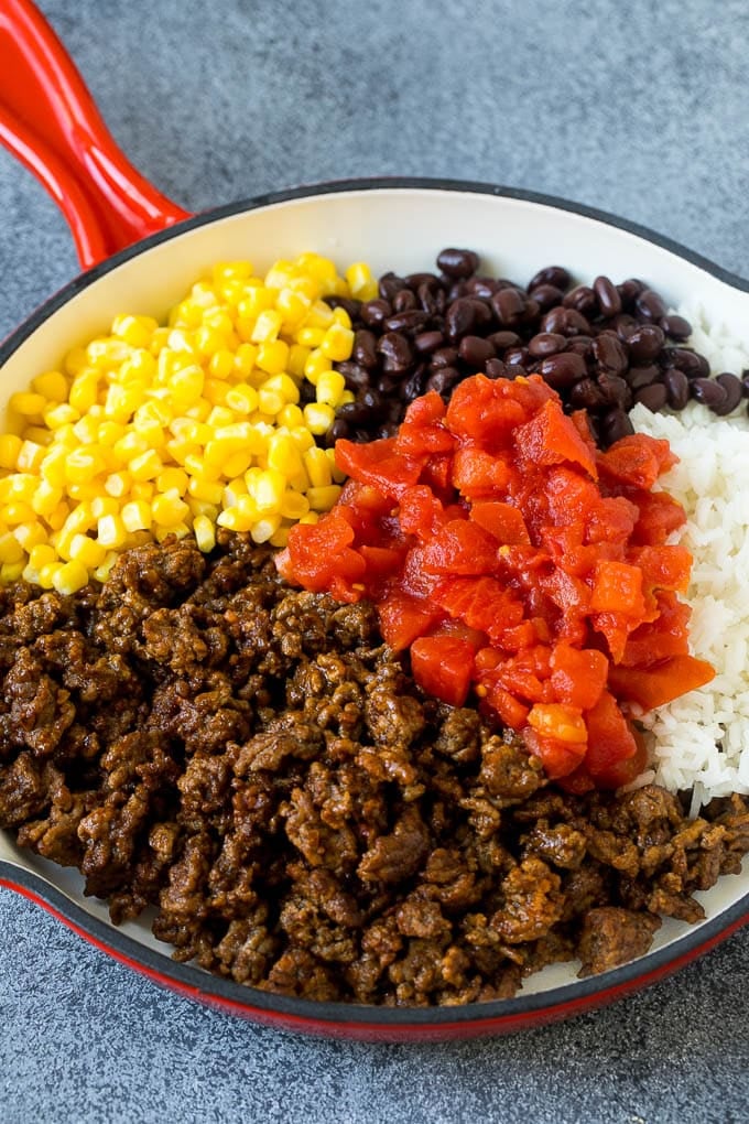 Stuffed Poblano Peppers | Stuffed Peppers | Pasilla Peppers #peppers #stuffedpeppers #beef #rice #beans #corn #dinner #jonep A skillet filled with ground beef, rice, tomatoes, beans and corn.