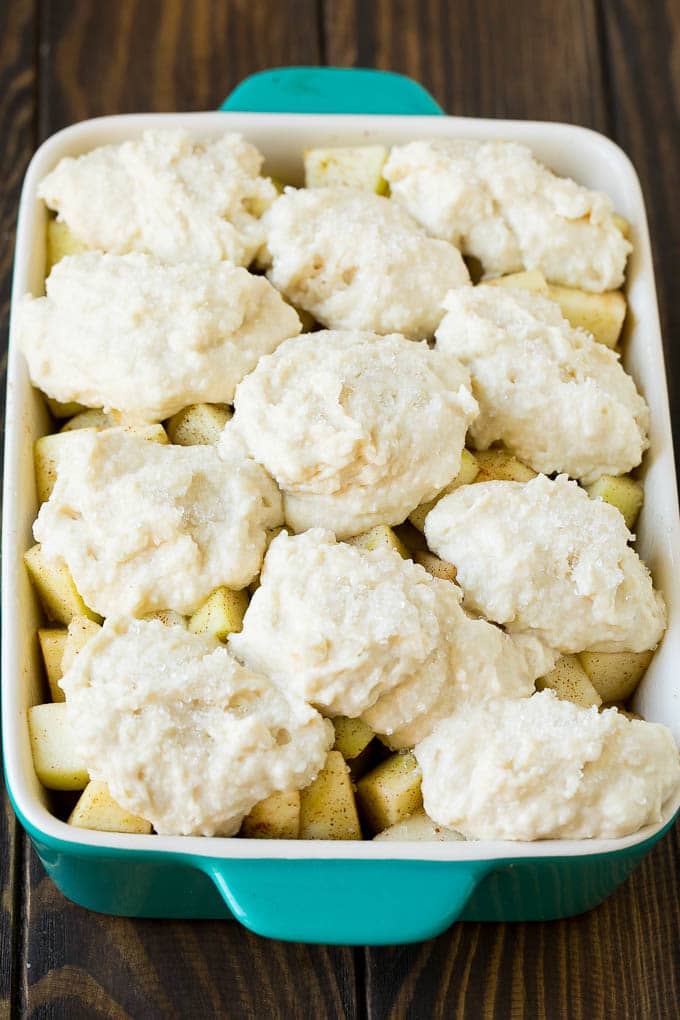 Apple Cobbler Recipe | Apple Dessert #apples #cobbler #dessert #baking #fall #jonep Fruit in a baking dish with dough over the top.