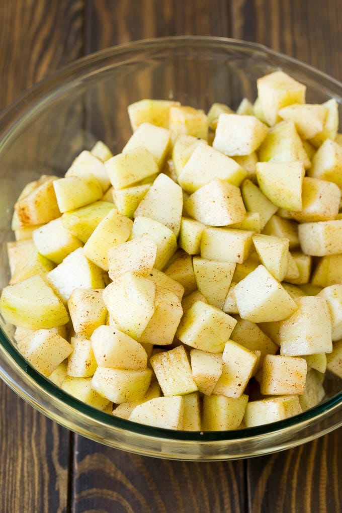 Apple Crisp Recipe | Apple Dessert #apples #dessert #baking #fall #jonep Diced apples tossed with sugar and cinnamon in a bowl.