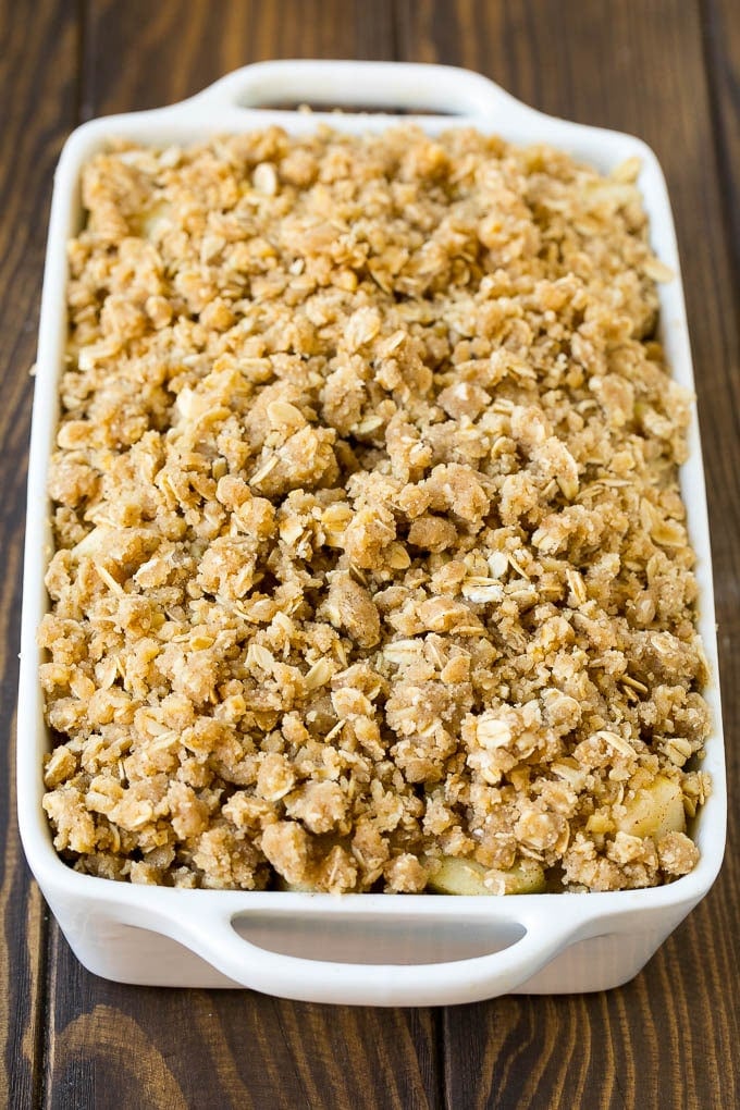 Apple Crisp Recipe | Apple Dessert #apples #dessert #baking #fall #jonep Apples in a baking dish topped with brown sugar crumble.