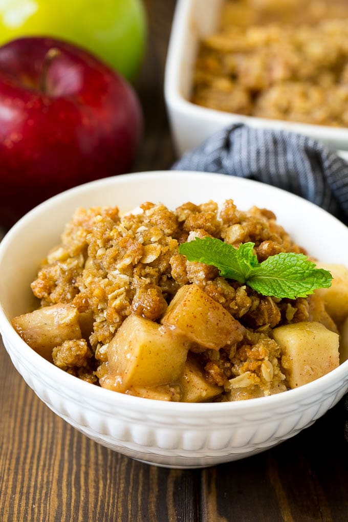 Apple Crisp Recipe | Apple Dessert #apples #dessert #baking #fall #jonep A bowl of apple crisp garnished with a sprig of mint.