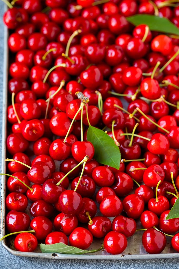 Cherry Pie Filling Recipe #pie #cherries #dessert #sweets #jonep #summer Fresh cherries spread out on a sheet pan.