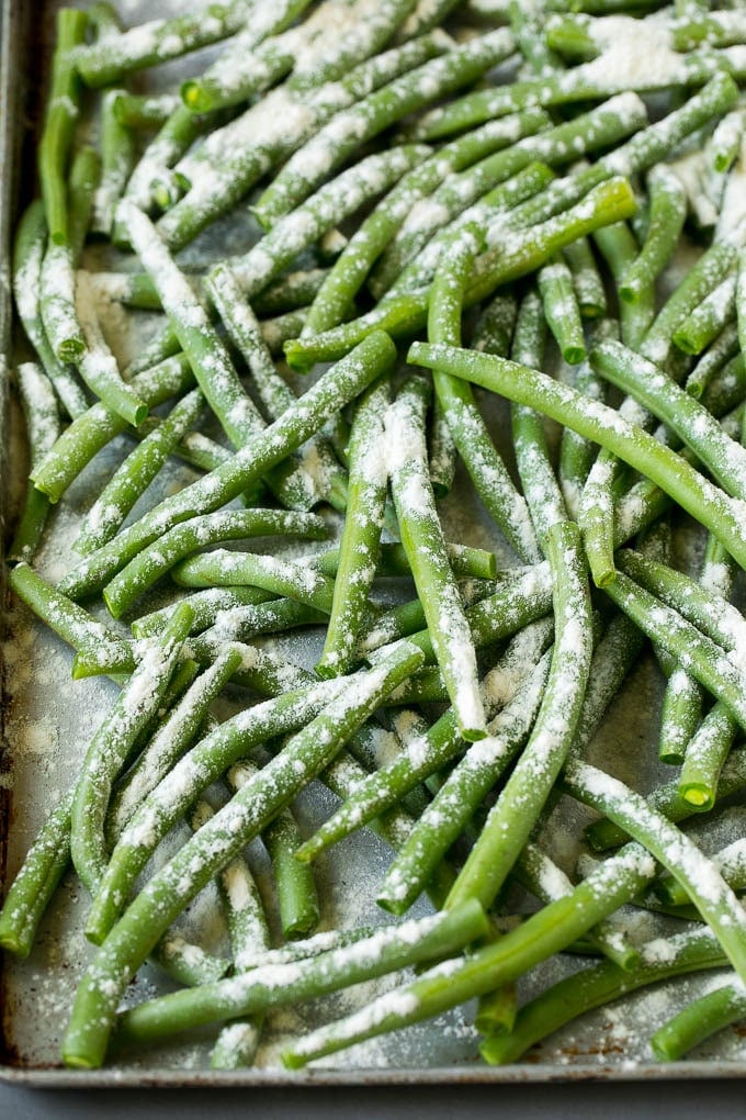 Fried Green Beans Recipe | Green Beans #greenbeans #appetizer #snack #jonep Bean coated in flour on a pan.