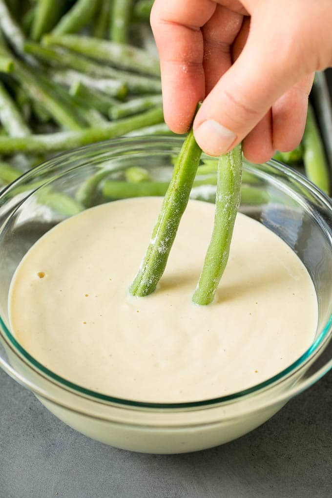 Fried Green Beans Recipe | Green Beans #greenbeans #appetizer #snack #jonep A hand dipping beans into beer batter.