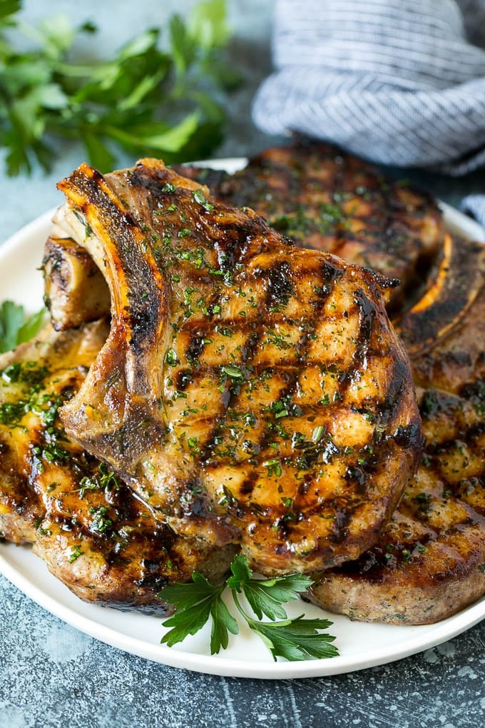 Grilled Pork Chops | Pork Chop Marinade #porkchops #grilling #pork #marinade #dinner #jonep Grilled pork chops coated in marinade then cooked and garnished with parsley.