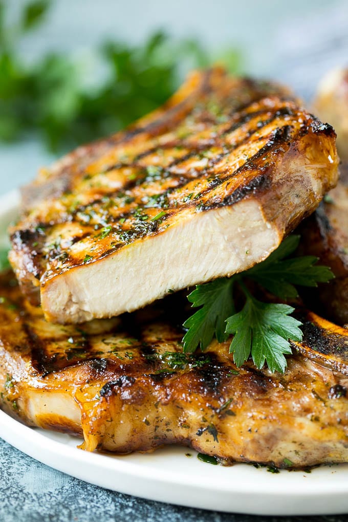 Grilled Pork Chops | Pork Chop Marinade #porkchops #grilling #pork #marinade #dinner #jonep Grilled pork chops with a cut chop on top of the stack.