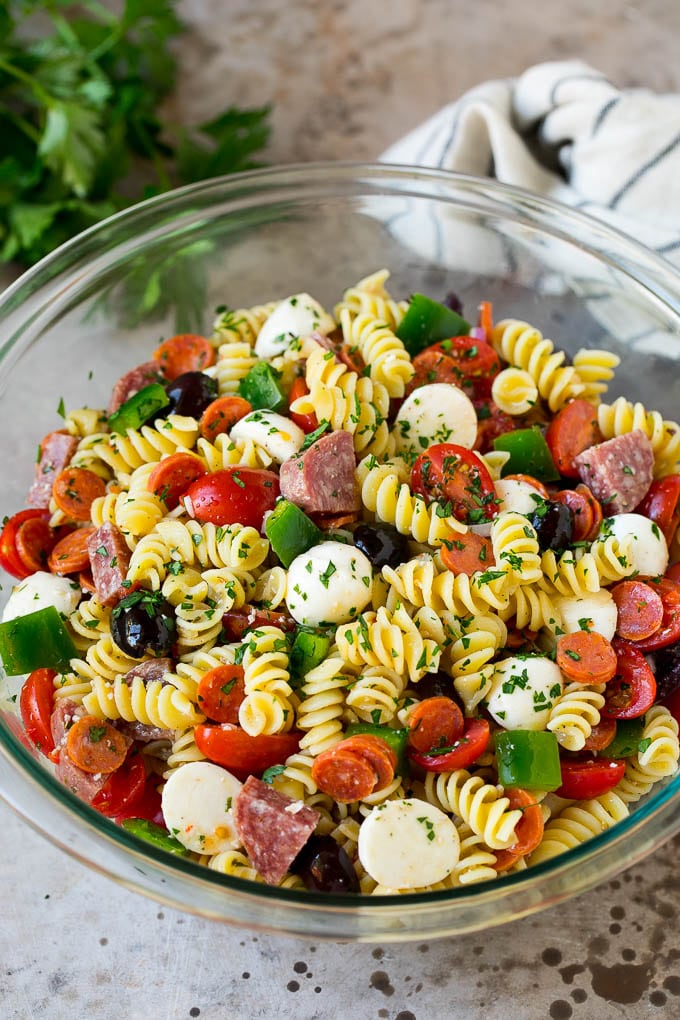 Italian Pasta Salad | Pasta Salad Recipe #pasta #salad #pastasalad #pepperoni #salami #olives #cheese #sidedish #jonep A bowl of Italian pasta salad filled with meats, cheese and vegetables.