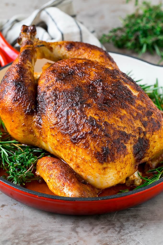 Rotisserie Chicken Recipe | Roasted Chicken #chicken #dinner #jonep #comfortfood Rotisserie chicken in a skillet garnished with fresh herbs.
