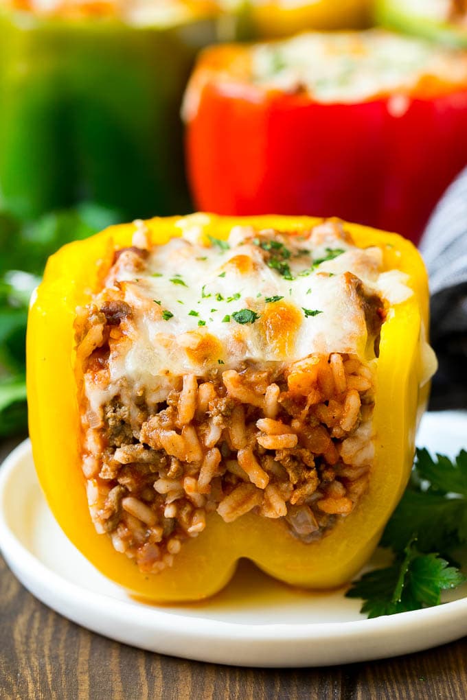 Stuffed Bell Peppers Recipe | Stuffed Peppers #beef #rice #peppers #dinner #cheese #jonep A stuffed bell pepper cut open on a plate.