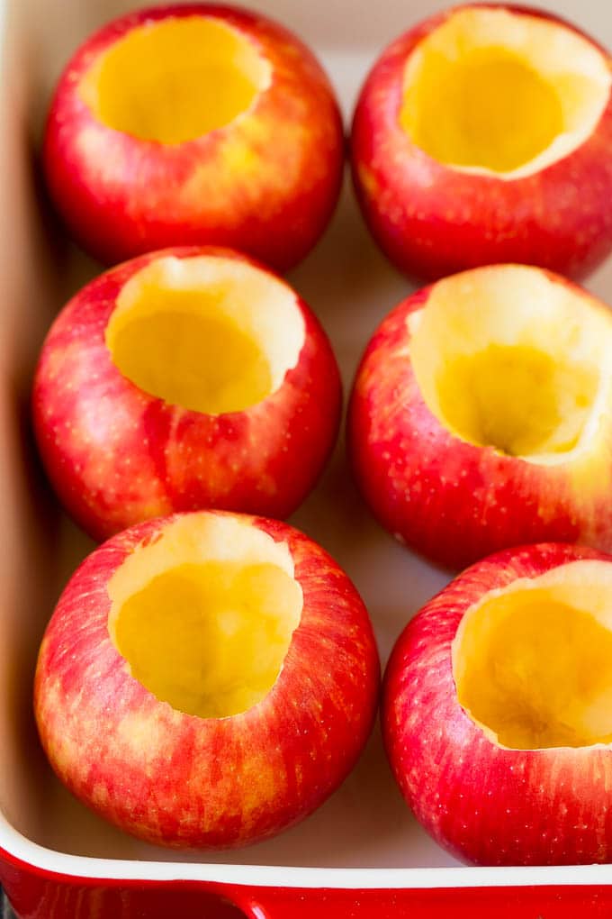 Baked Apples | Stuffed Apples #apples #fall #dessert #sweettooth #jonep Hollowed out apples in a baking dish.