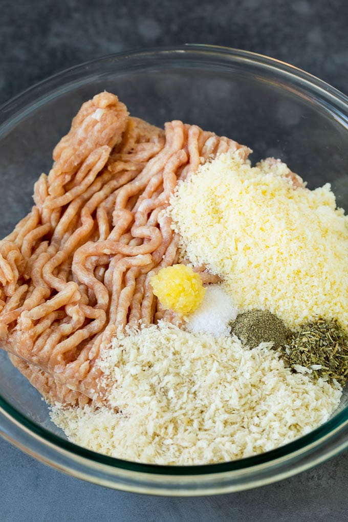 Chicken Meatballs Recipe | Baked Meatballs #chicken #meatballs #dinner #jonep #comfortfood Ground chicken, herbs, breadcrumbs and cheese in a mixing bowl.