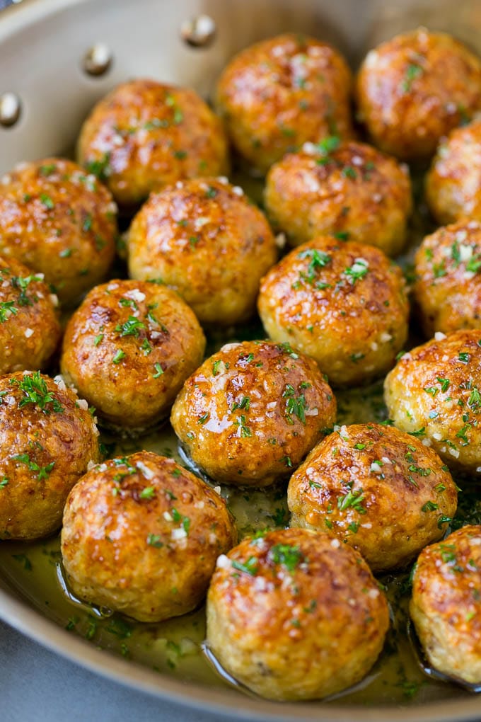 Chicken Meatballs Recipe | Baked Meatballs #chicken #meatballs #dinner #jonep #comfortfood Chicken meatballs in a skillet of garlic butter.