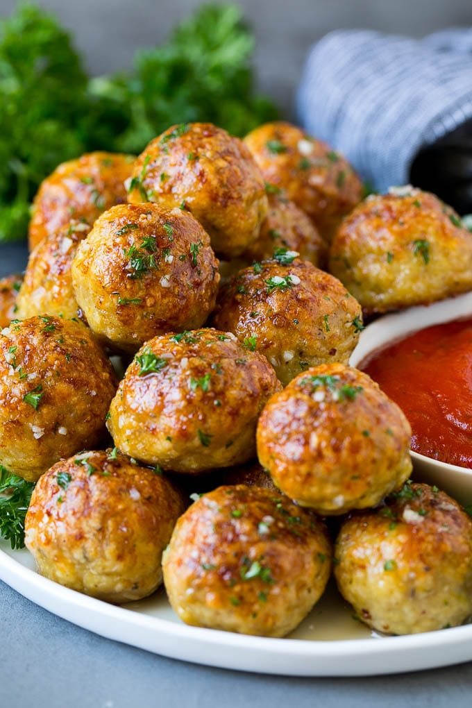 Chicken Meatballs Recipe | Baked Meatballs #chicken #meatballs #dinner #jonep #comfortfood A serving plate of chicken meatballs served with marinara sauce.