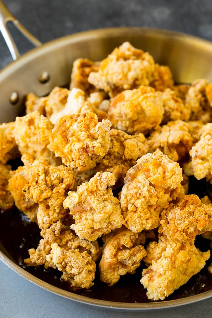 General Tso's Chicken Recipe #chicken #asianfood #dinner #jonep #copycatrecipe Crispy chicken in a skillet filled with savory and spicy sauce.