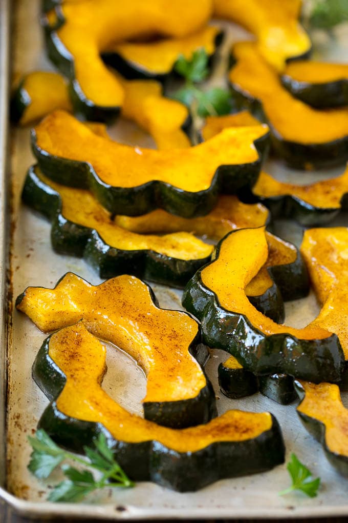 Roasted Acorn Squash | Acorn Squash Recipe #squash #winter #sidedish #dinner #jonep Roasted acorn squash garnished with fresh parsley.