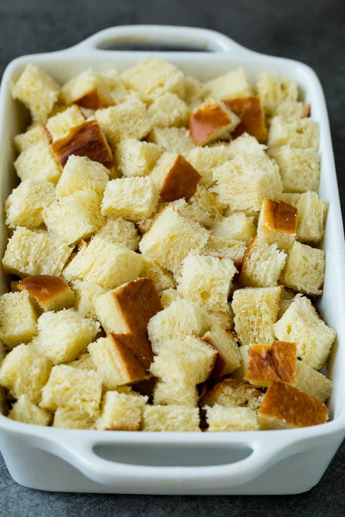French Toast Casserole Recipe | French Toast Bake #frenchtoast #casserole #breakfast #brunch #jonep #bread Cubes of bread in a baking dish.