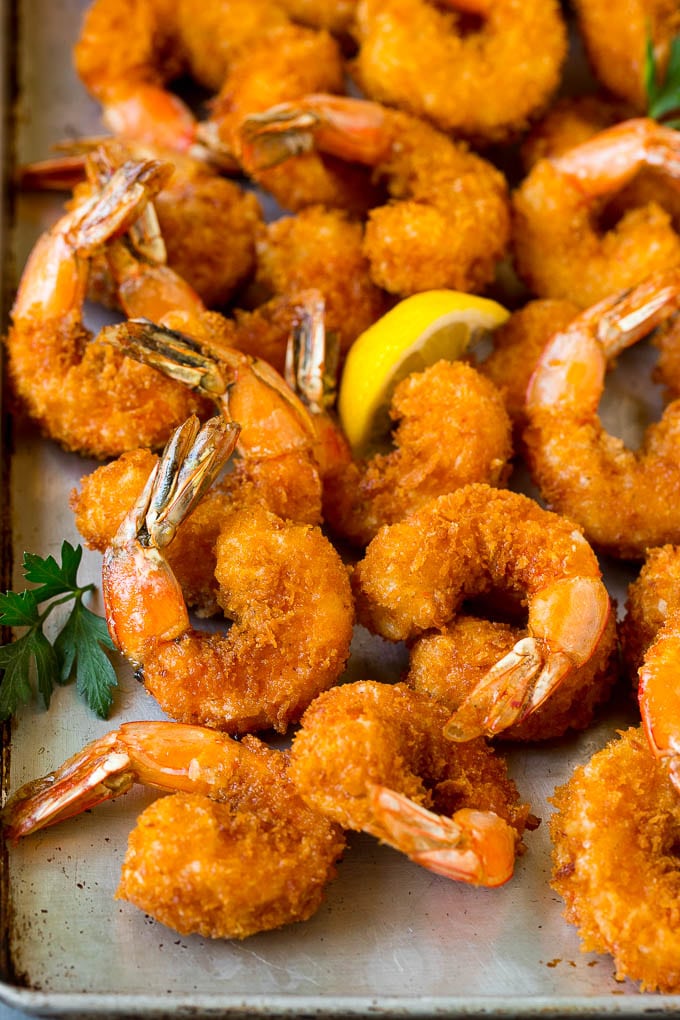 Fried Shrimp Recipe #shrimp #seafood #dinner #appetizer #jonep Fried shrimp on a sheet pan garnished with parsley and lemon.
