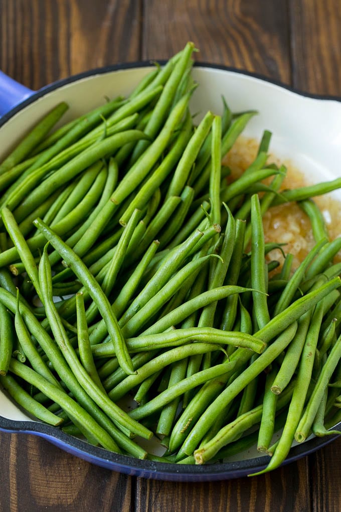 Green Beans with Bacon Recipe | Bacon Green Beans #bacon #greenbeans #sidedish #thanksgiving #veggies #dinner #jonep Beans in a pan with onions.