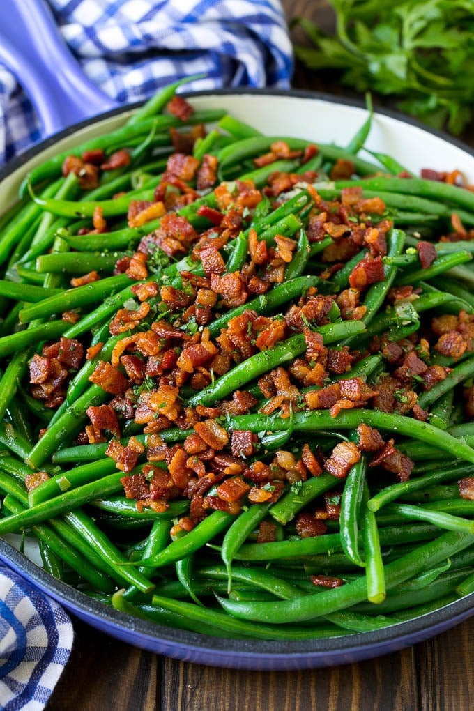 Green Beans with Bacon Recipe | Bacon Green Beans #bacon #greenbeans #sidedish #thanksgiving #veggies #dinner #jonep Green beans with bacon in a skillet, topped with parsley.