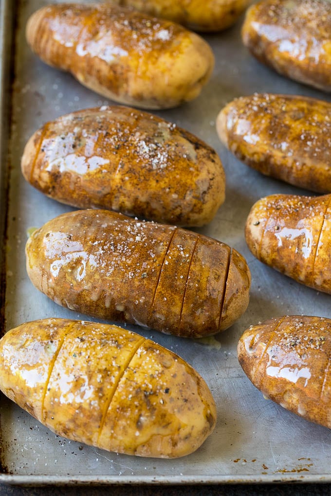 Hasselback Potatoes Recipe #potatoes #bacon #sidedish #cheese #dinner #jonep Potatoes on a sheet pan coated in olive oil and butter.