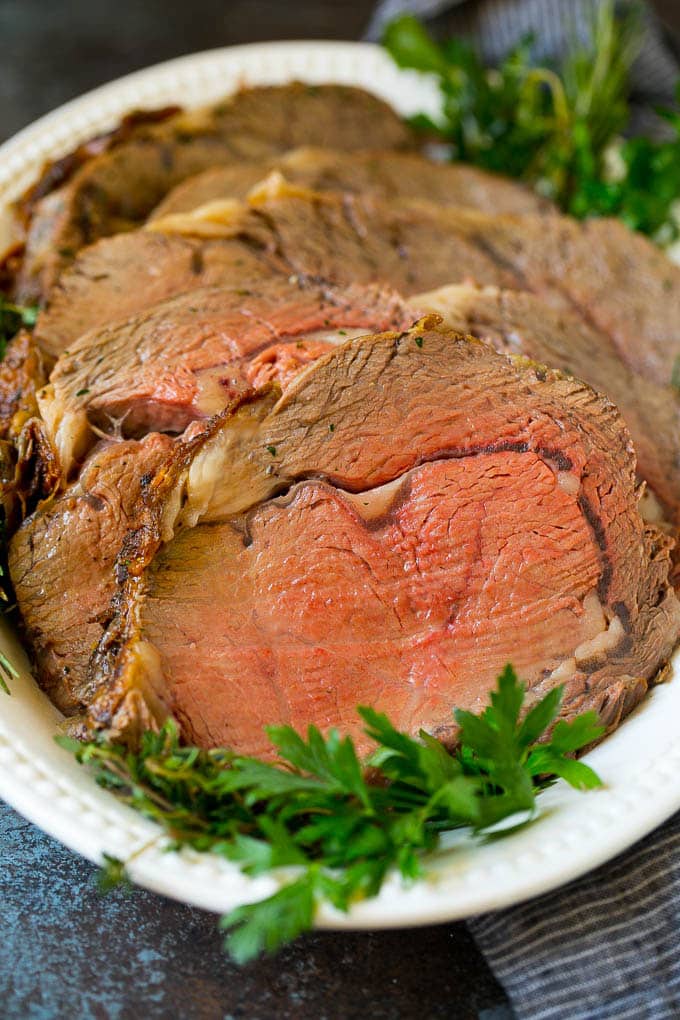 Prime Rib Recipe #primerib #beef #roast #dinner #thanksgiving #christmas #keto #lowcarb #jonep Sliced slow roasted prime beef on a serving platter.