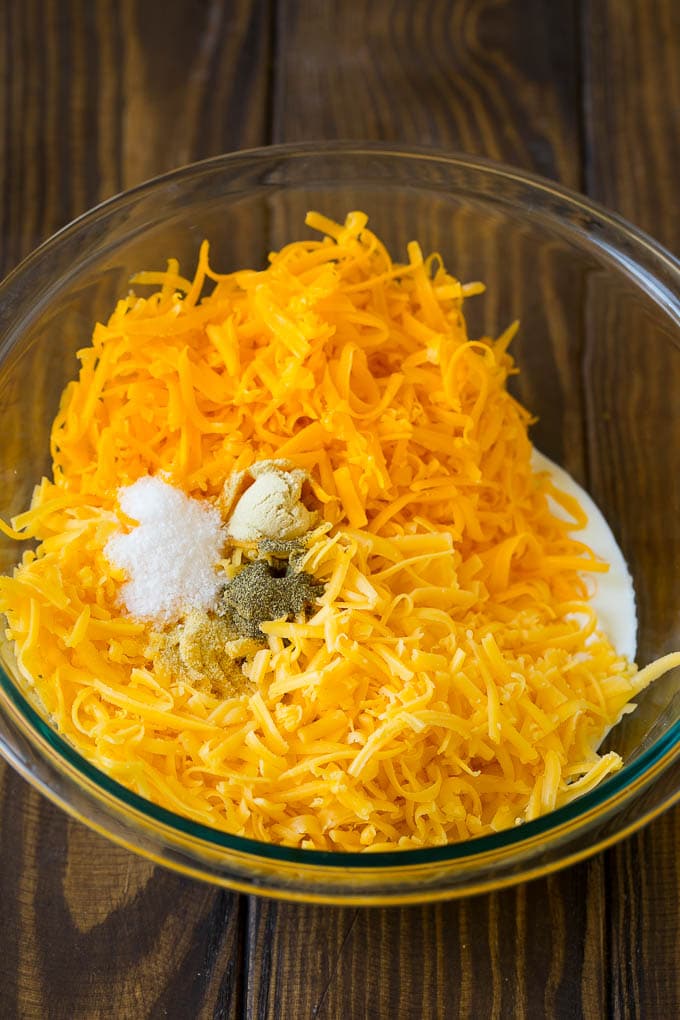 Southern Mac and Cheese | Baked Macaroni and Cheese #pasta #macandcheese #dinner #comfortfood #cheese #jonep A bowl of milk, cream, two types of shredded cheese and seasonings.