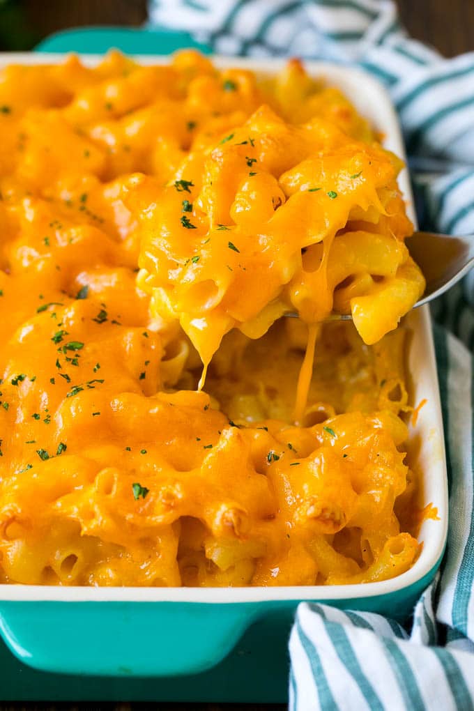 Southern Mac and Cheese | Baked Macaroni and Cheese #pasta #macandcheese #dinner #comfortfood #cheese #jonep A spoon serving up a portion of Southern mac and cheese.