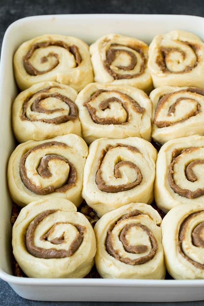Sticky Buns Recipe | Sweet Rolls | Cinnamon Rolls #breakfast #brunch #cinnamon #pecans #jonep #bread Cinnamon swirl dough in a baking dish.
