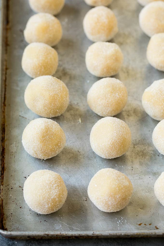 Thumbprint Cookies | Sugar Cookies #cookies #baking #christmas #dessert #jonep Balls of cookie dough rolled in sugar.