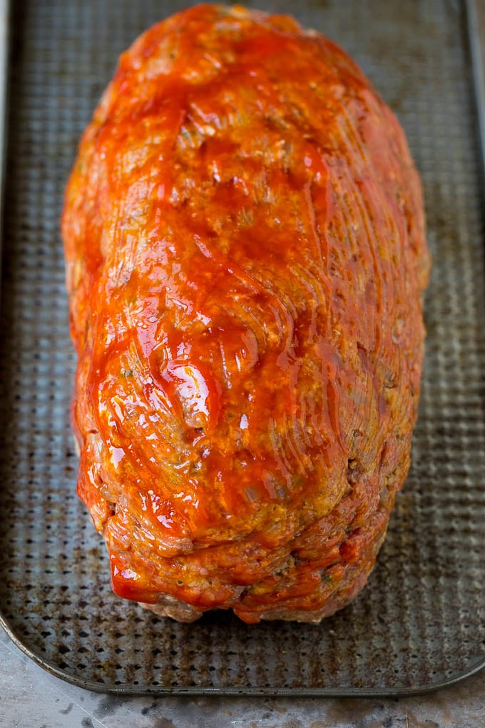 Bacon Wrapped Meatloaf Recipe | Beef Meatloaf #meatloaf #beef #groundbeef #bacon #dinner #jonep Ground beef shaped into a loaf and coated in ketchup.